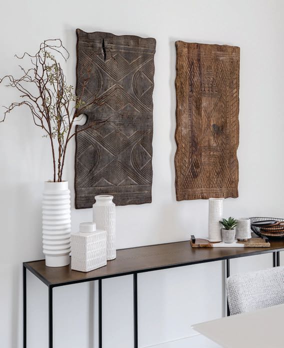 Wood wall carvings from Anthropologie (anthropologie.com) decorate the walls in the dining room. Photographed by Drufer Photography