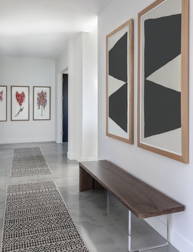 Soicher Marin and original art owned by the client is showcased in the entry. Photographed by Drufer Photography