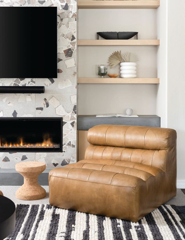 A comfortable leather lounge chair sits atop a Loloi rug in the living room PHOTOGRAPHED BY KEVIN BROST