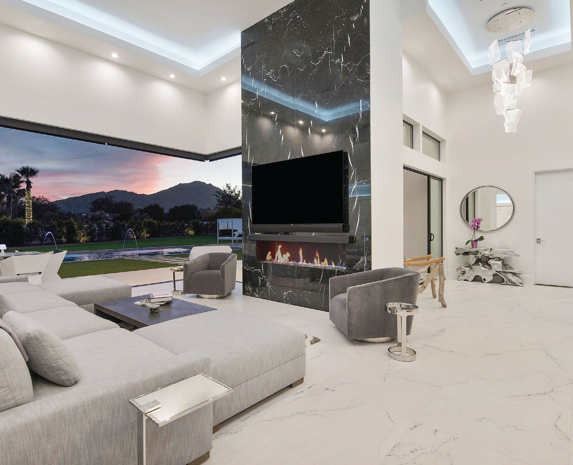 The fireplace accent wall in the living room is the star of the show, using Arizona Title’s black marble tile PHOTO COURTESY OF RMB LUXURY REAL ESTATE