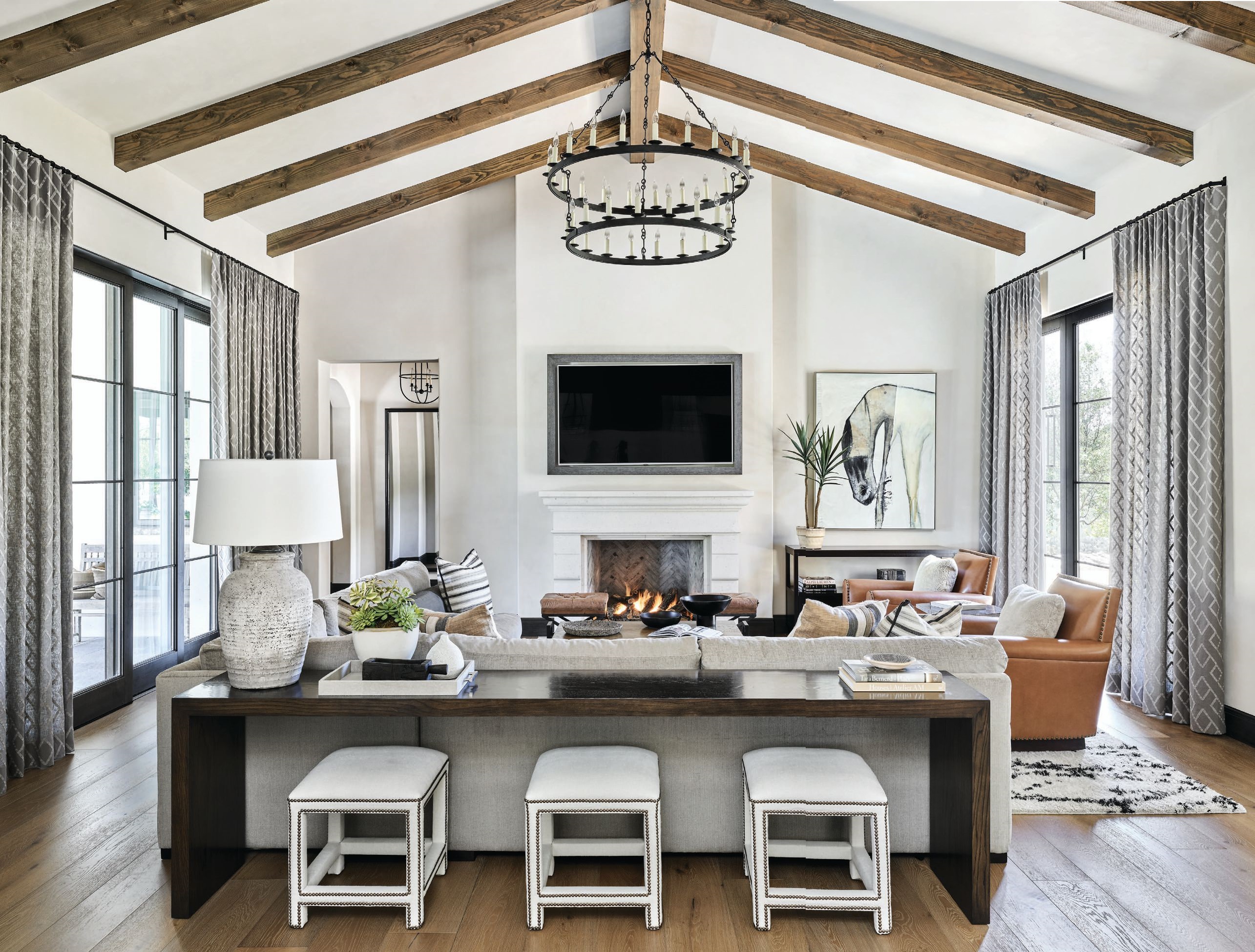 “The living room is the ultimate gathering space with generous and comfortable seating for all with a fabulous stone fireplace and a large TV,” says DeCesare PHOTOGRAPHED BY WERNER SEGARRA