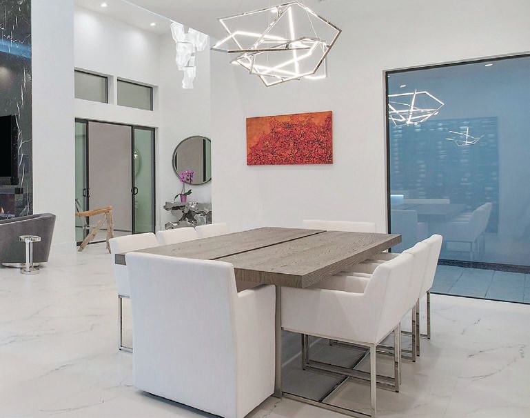 A Trapezoid chandelier from ET2 Contemporary Lighting brightens the dining room PHOTO COURTESY OF RMB LUXURY REAL ESTATE