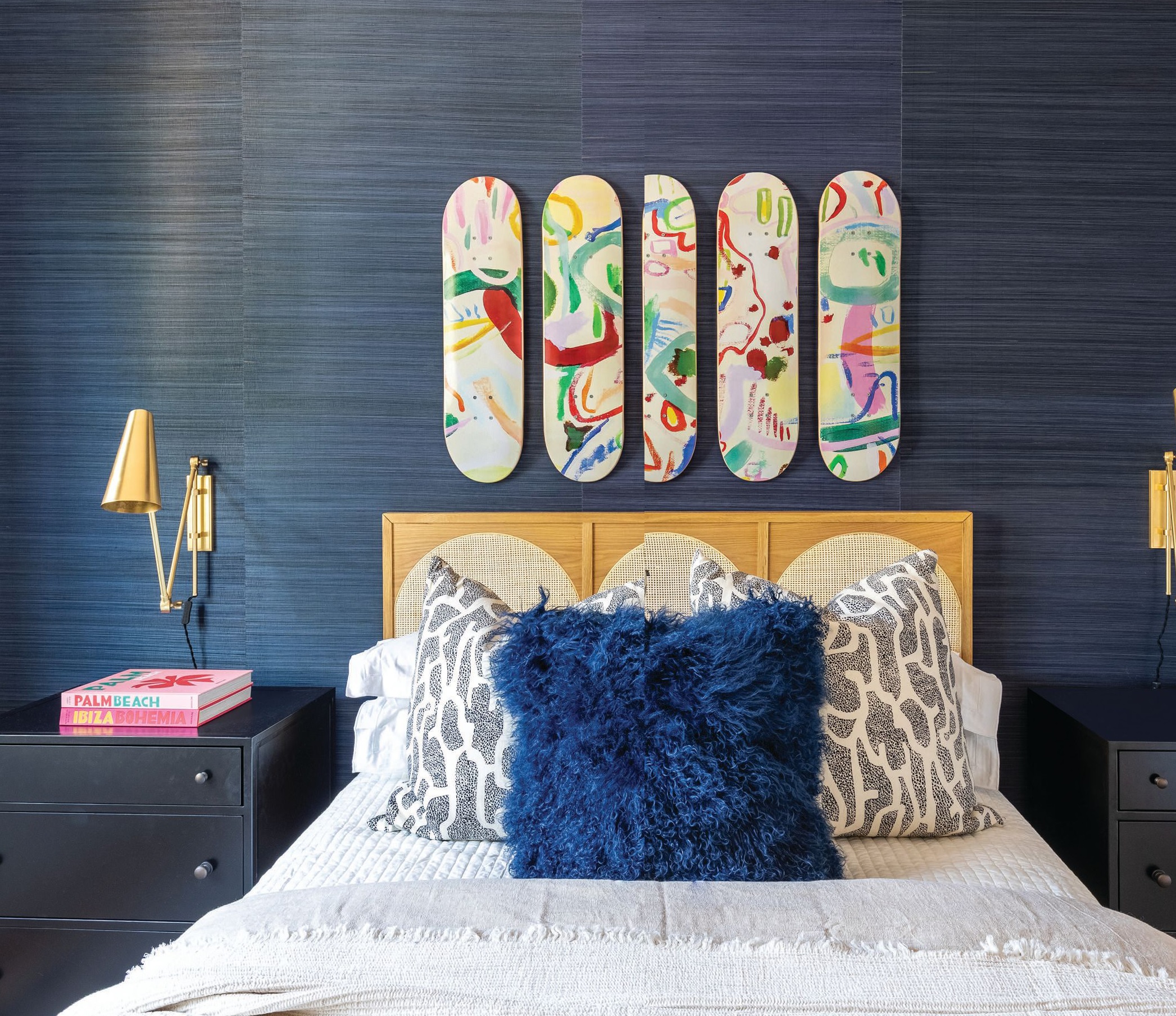One of the daughters requested a beachy bedroom, and Yeates delivered a unique take on the idea via deep-blue Schumacher wallpaper and surfboard-inspired art from Etsy. Photographed by Flourish Photography 