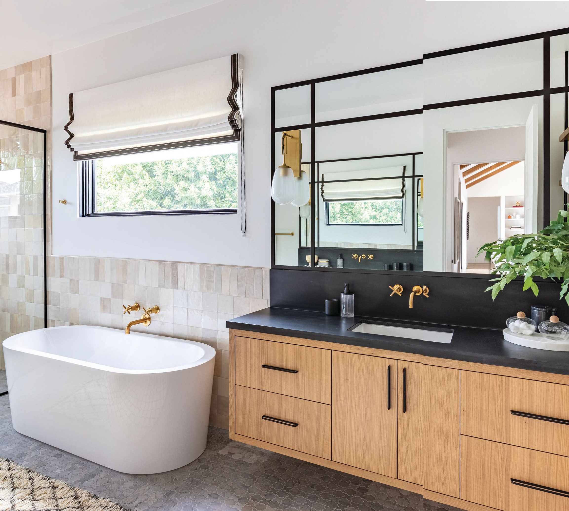 Soft shapes and textures bring warmth to the primary bathroom. Photographed by Flourish Photography