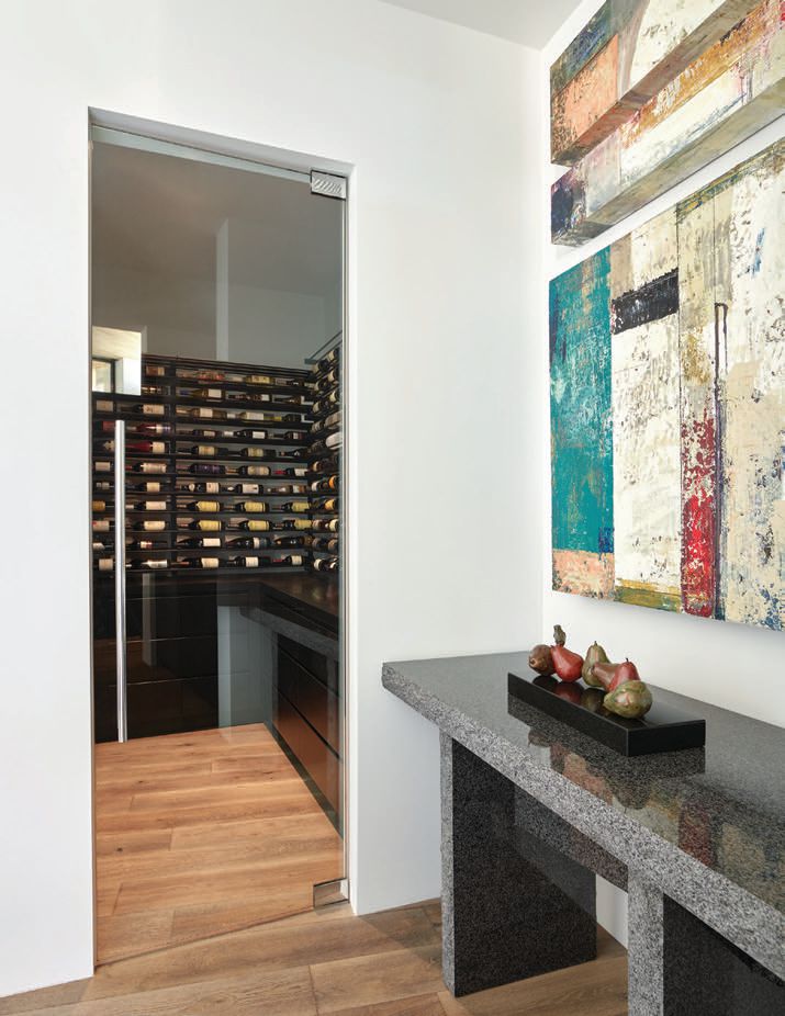 The refrigerated wine room displays the homeowners’ bottles as works
of art, and includes an area for food prep and storage. PHOTOGRAPHED BY WERNER SEGARRA