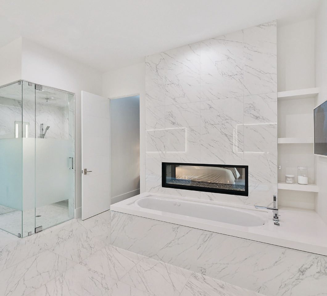 Arizona Tile’s polished and honed white marble porcelain tile surrounds the primary bathroom PHOTO COURTESY OF RMB LUXURY REAL ESTATE