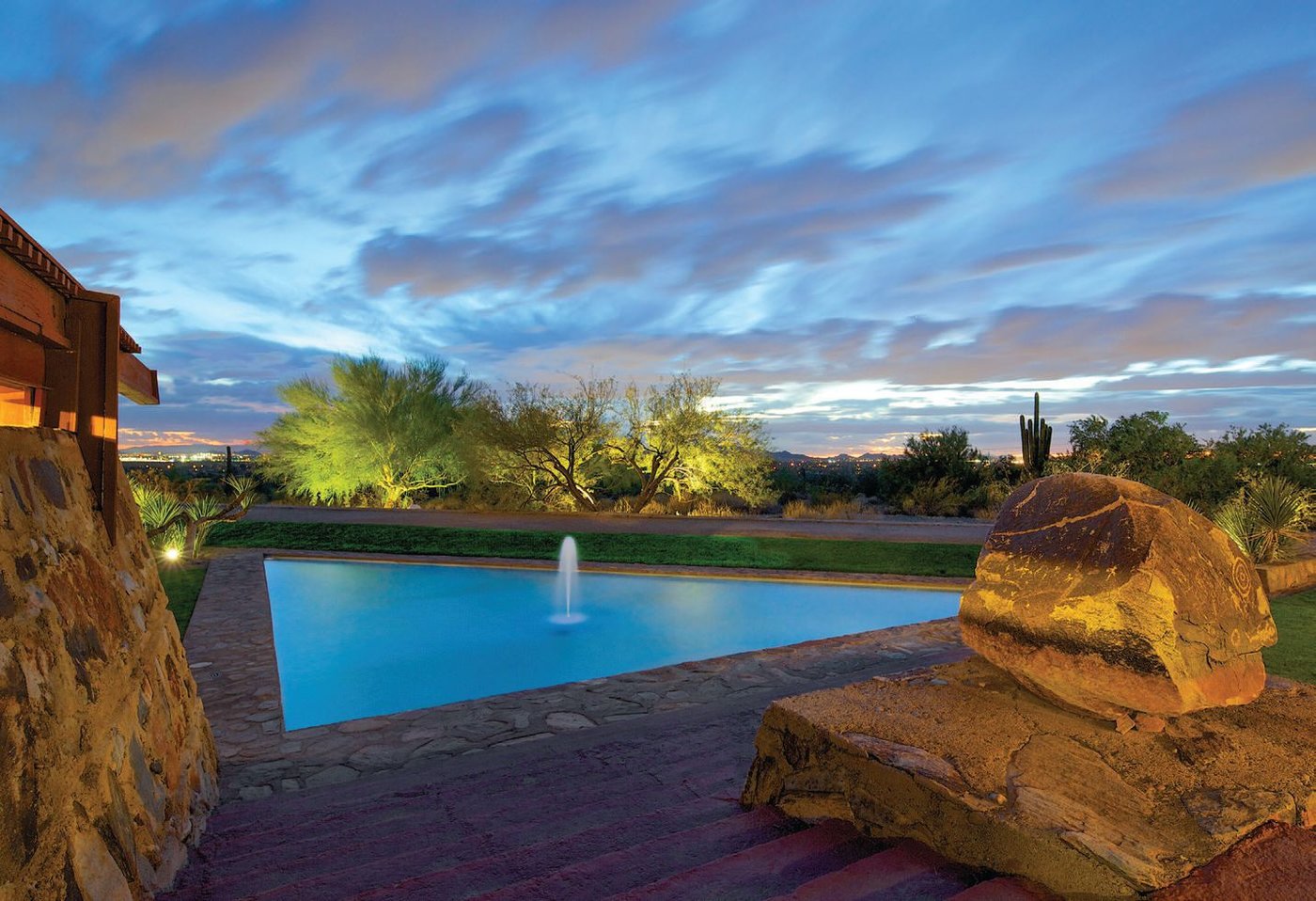 The exterior of Frank Lloyd Wright’s Taliesin West and reflecting pond at dusk PHOTO: BY ANDREW PIELAGE FOR TALIESIN WEST