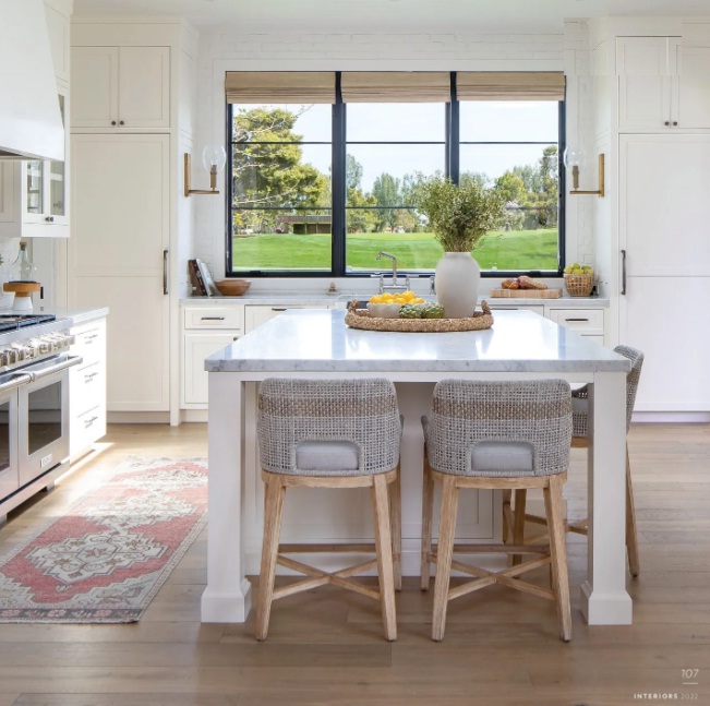 Two large windows and a skylight flood the kitchen with natural light. A vintage runner from NoMad Design adds a subtle hint of color. Photographed by Ryan Garvin