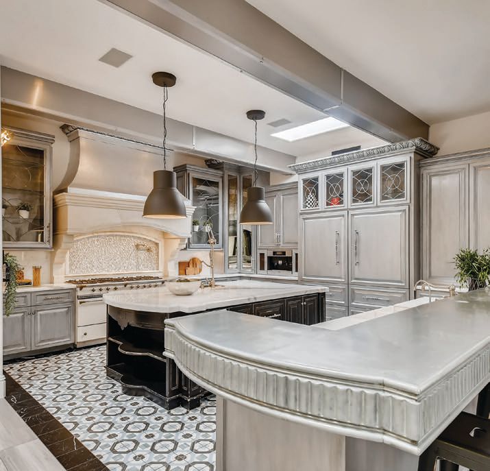 The gourmet kitchen features custom cabinetry, a mix of zinc and marble slab countertops and an impressive 71-inch Lacanche gas range. PHOTO BY VIRTUANCE REAL ESTATE PHOTOGRAPHY