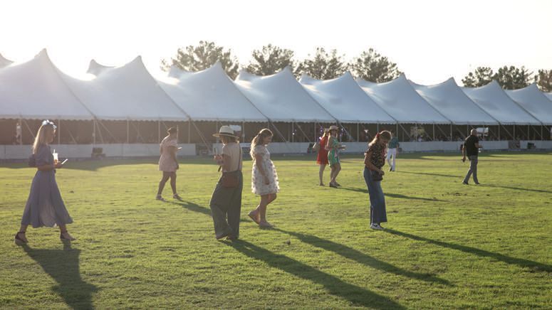 Attendees hit the field for the stomping of the divots. PHOTO BY CARRIE EVANS / THE POLO PARTY