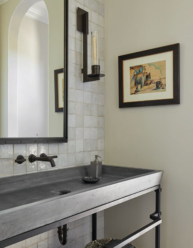 A concrete sink by Calvis Wyant stands out against white zellige tile and a Restoration Hardware mirror PHOTOGRAPHED BY LAURA MOSS